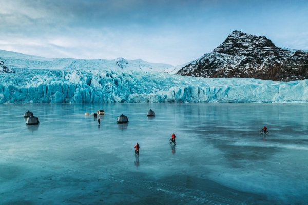 Cycling on frozen lake Remote Glacier Camp Fjallsarlon Iceland