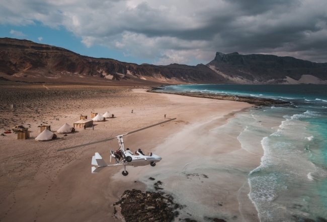 Gyrocopter over beach camp Socotra by Louis Waite Cookson Adventures